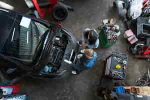 Free photo top view man repairing car