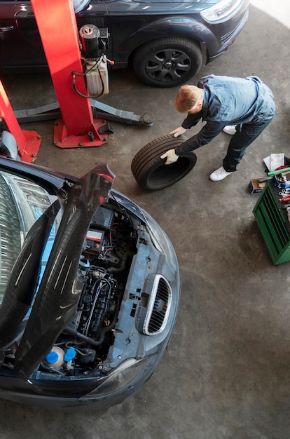 Free photo top view man repairing car