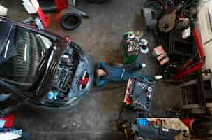 Free photo top view man repairing car