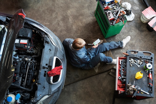 Top view man repairing car