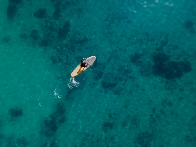 Top view man surfing with beautiful view