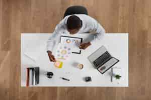 Free photo top view man working at desk