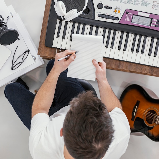 Top view man writing on notebook