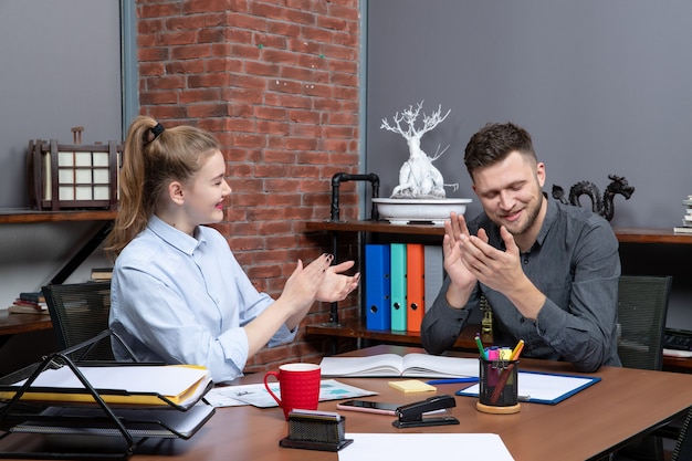 Free photo top view of management team sitting at the table came to negotiation in the meeting room at office