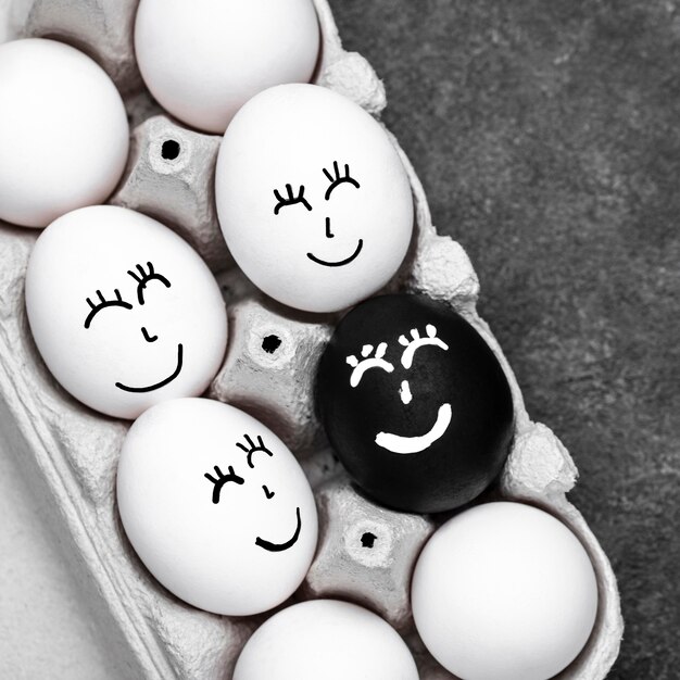 Top view of many different colored eggs with faces for black lives matter movement