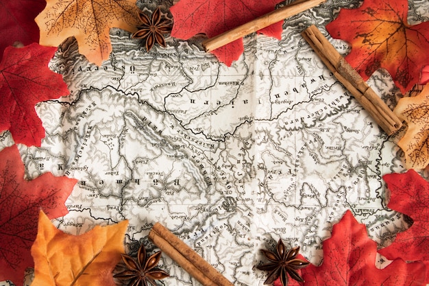 Top view map surrounded by autumn leaves