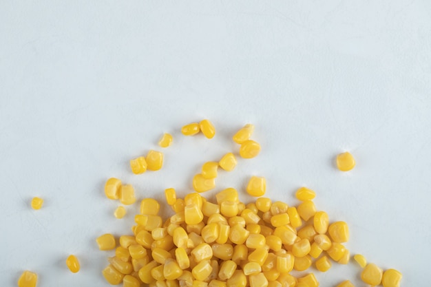 Free photo top view. marinated corn seeds on white background.