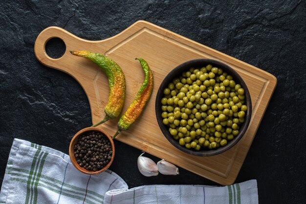 Top view. Marinated green peas . Dried peppers.