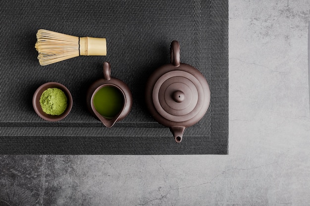 Top view of matcha tea with teapot