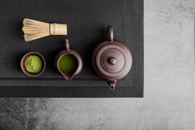 Top view of matcha tea with teapot