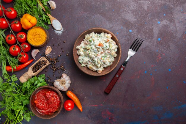 Top view mayyonaise salad with fresh vegetables and greens on dark space