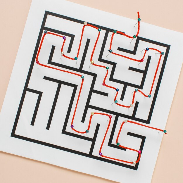 Top view maze on paper with thread