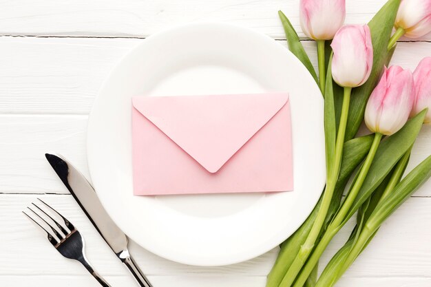 Top view meal prepared with tulips beside