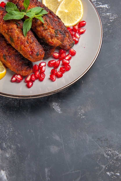 Top view meat cutlets long formed with lemon slices