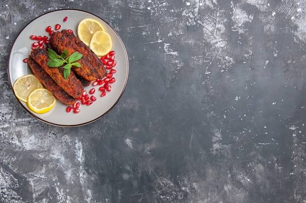 Top view meat cutlets long formed with lemon slices