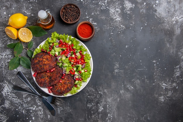 Top view meat cutlets with salad and bread