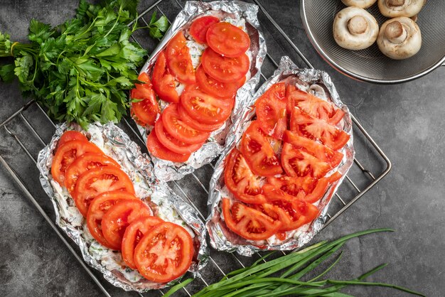 Top view of meat dish with tomatoes and mushrooms