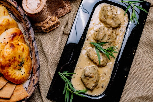 Top view meat in mushroom sauce with bread on the table