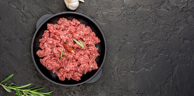 Top view of meat on plate with herbs and copy space