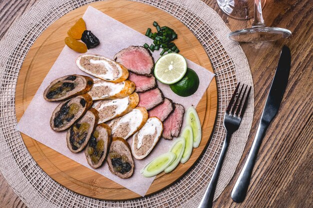 Top view meat plate with lime and onion