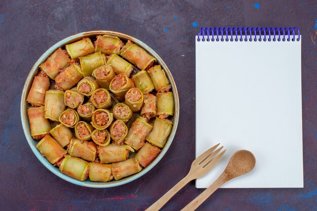 Top view meat rolls rolled with vegetables inside pan with notepad on the dark background meat dinner food vegetable meal