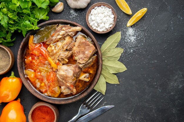 Top view meat soup with greens and seasonings on dark meat color gray sauce meal hot food potato photo dinner dish