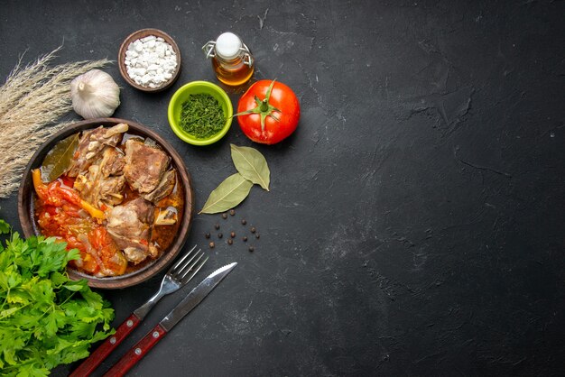 Top view meat soup with greens and tomato on dark meat color gray sauce meal hot food potato photo dinner dish