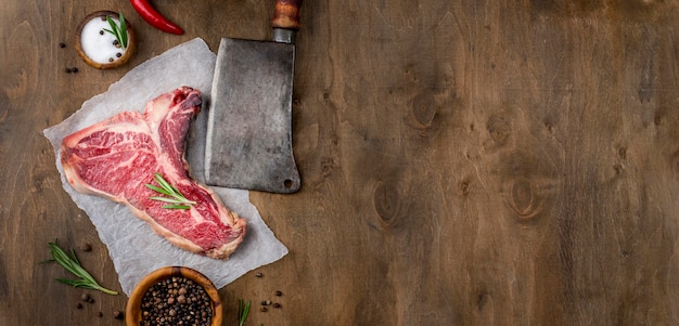 Top view of meat with herbs and copy space