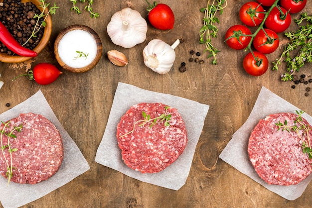 Top view of meat with herbs and garlic