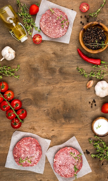 Free photo top view of meat with herbs and tomatoes