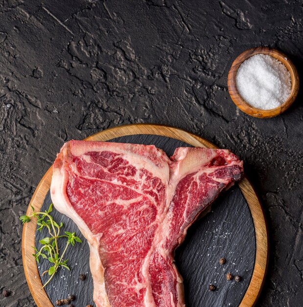 Top view of meat with salt on slate