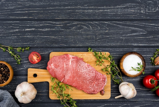 Top view of meat with tomatoes and copy space