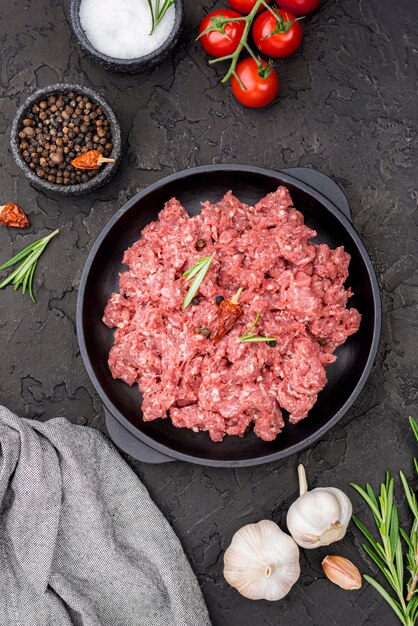 Top view of meat with tomatoes and spices