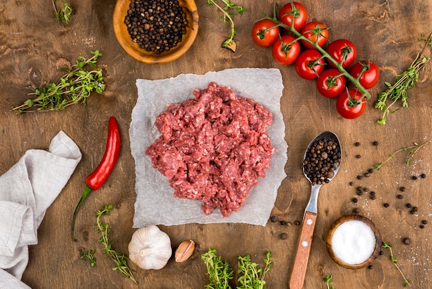 Top view of meat with tomatoes and spices