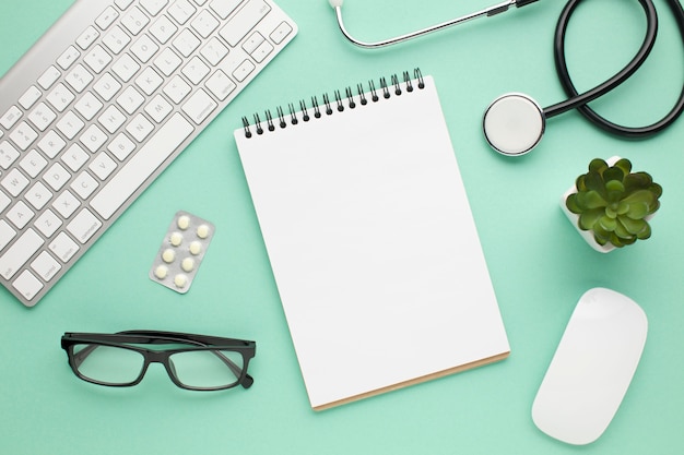 Top view of medical accessories on green desk