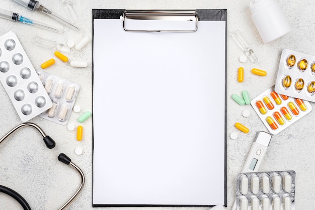 Free photo top view medical objects assortment with empty clipboard