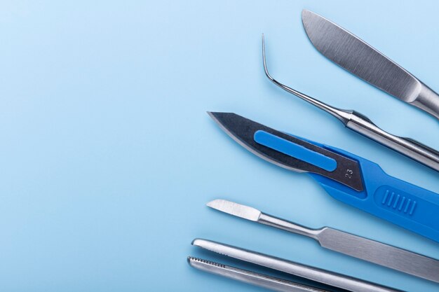Top view of medical scalpel with other instruments for medicine
