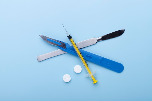 Top view of medical scalpel with other instruments for medicine