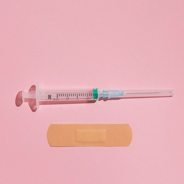 Top view medical syringe with band aid