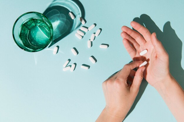 Top view medicine with water glass on the table