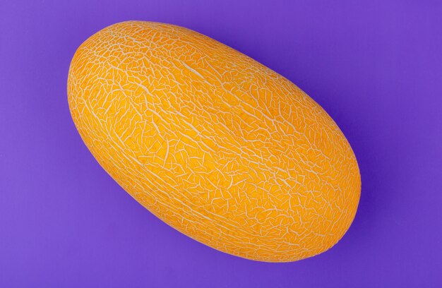 Top view of melon on purple background
