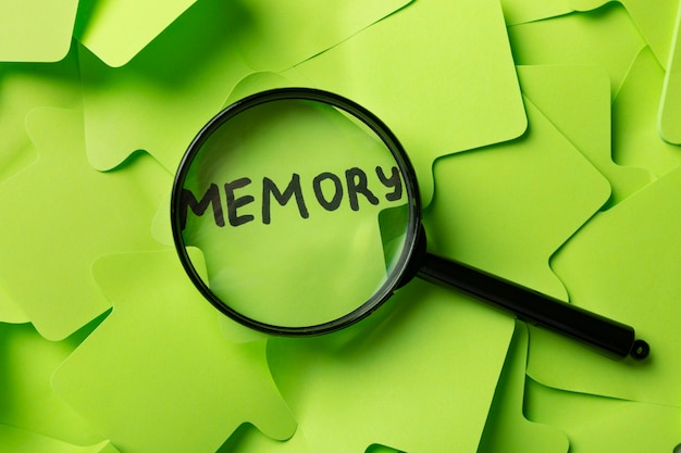 Top view memory concept with post its and magnifying glass