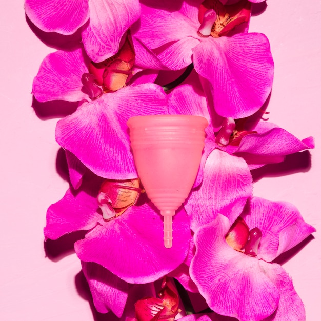 Top view menstrual cup with flowers