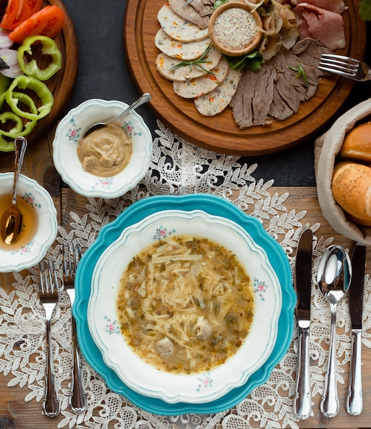 Top view of menu with soup and meat