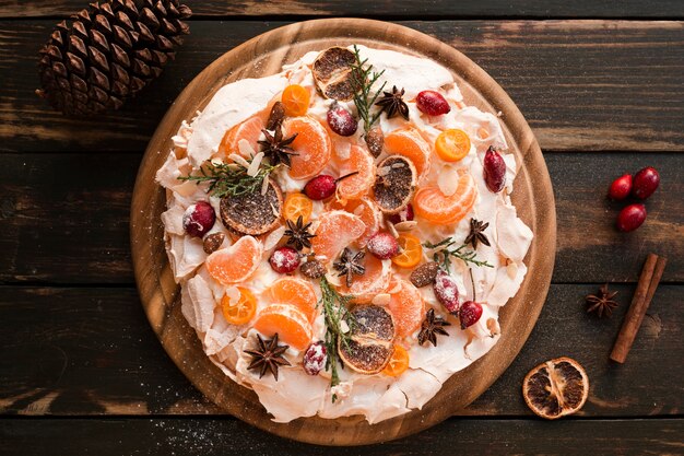 Top view of meringue cake with dried citrus and cinnamon