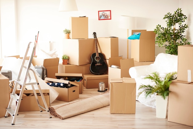 Top view of messy and full of moving boxes room