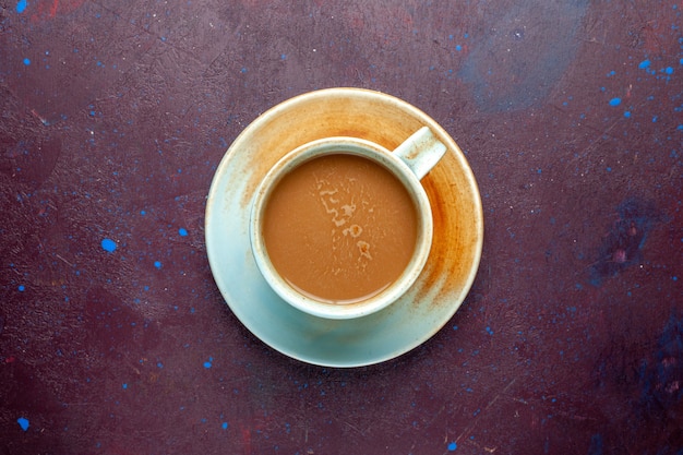 Top view milk coffee on the dark-eggplant colored background color milk drink