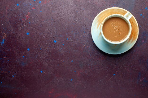 Top view milk coffee inside cup on the dark-eggplant colored background milk coffe drink taste espresso