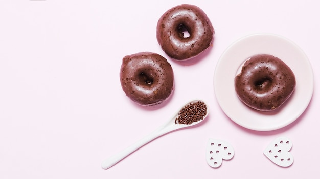 Top view mini donuts with paper hearts