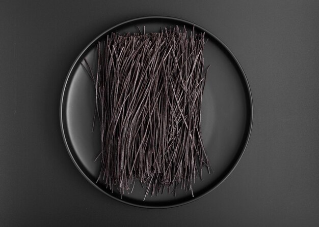 Top view minimalist plate with black spaghetti